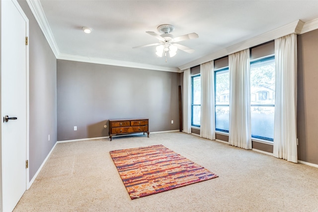 unfurnished room with ceiling fan, ornamental molding, carpet flooring, and baseboards