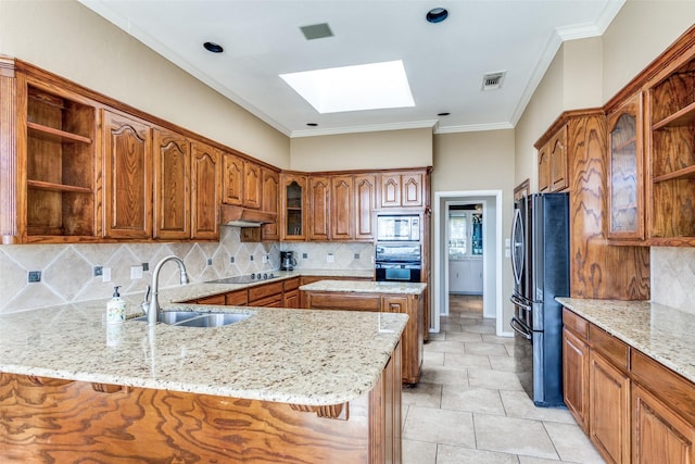 kitchen with a skylight, open shelves, brown cabinetry, a peninsula, and black appliances