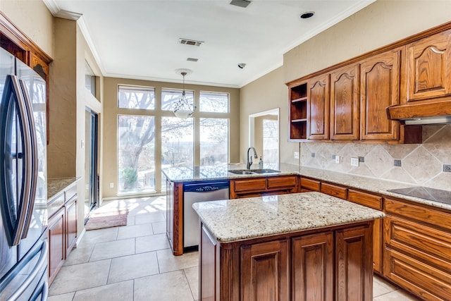 kitchen with decorative backsplash, appliances with stainless steel finishes, a peninsula, crown molding, and a sink