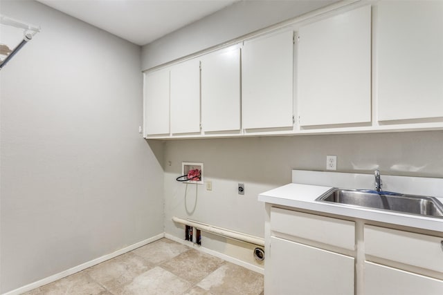 laundry area featuring hookup for a washing machine, cabinet space, a sink, electric dryer hookup, and baseboards