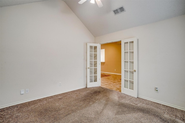 carpeted empty room featuring visible vents, baseboards, ceiling fan, vaulted ceiling, and french doors