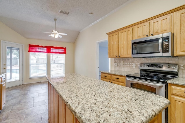 kitchen with visible vents, tasteful backsplash, appliances with stainless steel finishes, and a center island