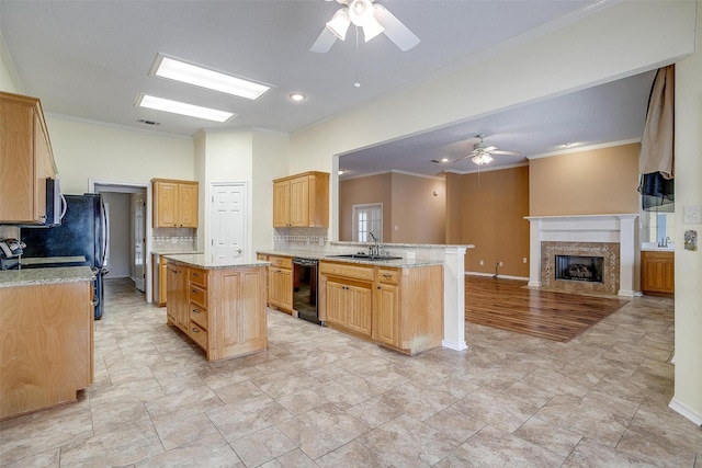 kitchen with open floor plan, dishwasher, ornamental molding, a peninsula, and a fireplace