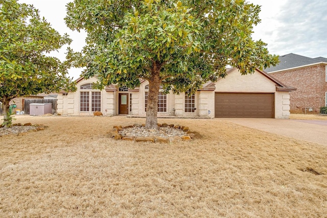 view of front of home featuring concrete driveway, an attached garage, and brick siding