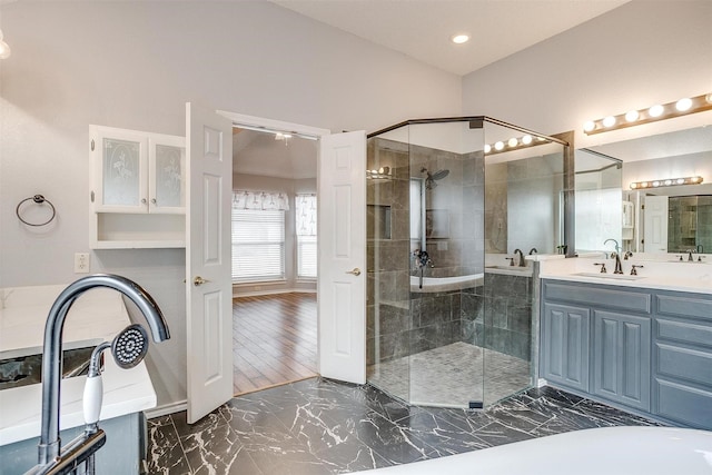 full bath with a shower stall, a washtub, recessed lighting, marble finish floor, and vanity