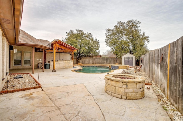 view of pool featuring a storage unit, a patio, a fenced backyard, an outdoor structure, and a fenced in pool