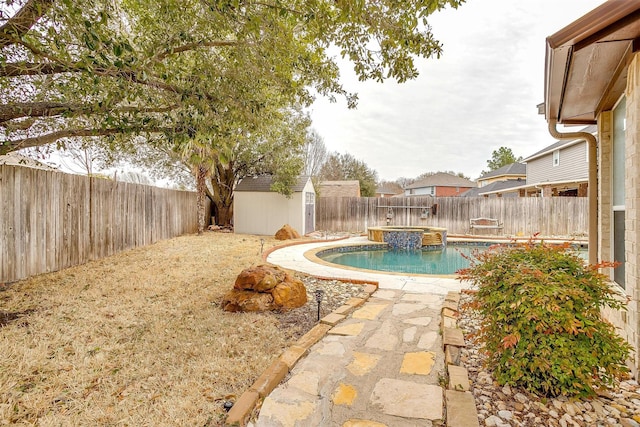 view of swimming pool with a storage shed, an outdoor structure, a fenced backyard, and a fenced in pool