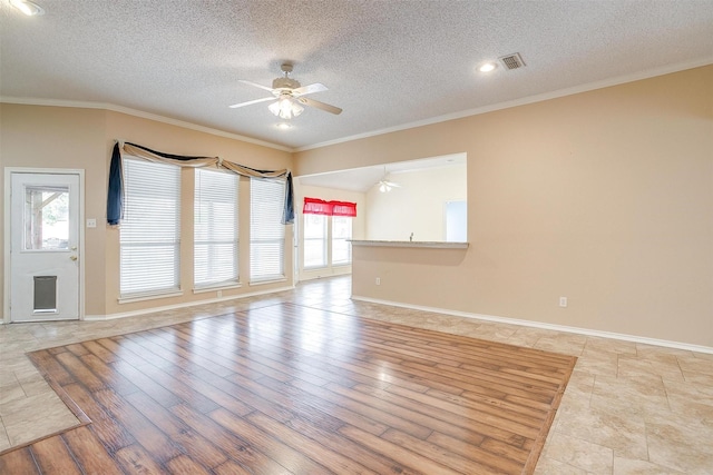 unfurnished living room with crown molding, visible vents, and ceiling fan