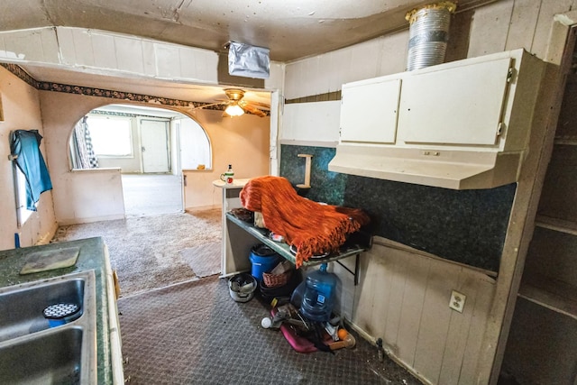 kitchen featuring carpet and white cabinetry