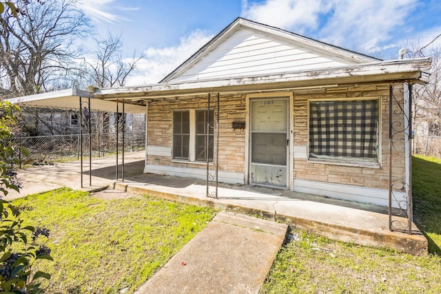 view of front of home featuring a patio area and fence