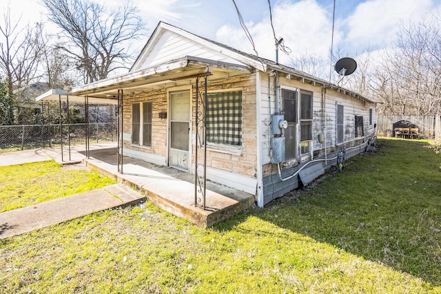 view of property exterior featuring a lawn and fence