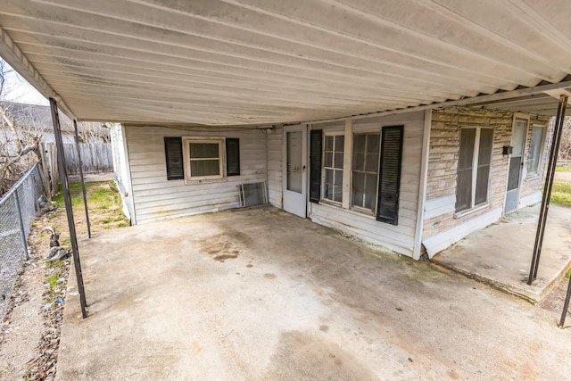 view of patio / terrace with a carport and fence