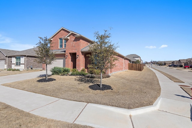 view of front facade with fence, a residential view, concrete driveway, a garage, and brick siding