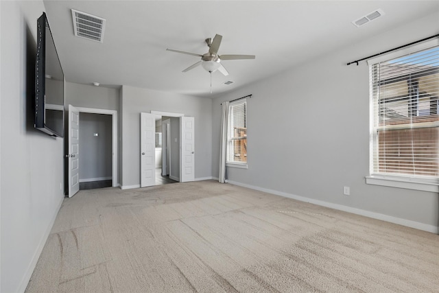 unfurnished bedroom featuring visible vents, baseboards, and carpet