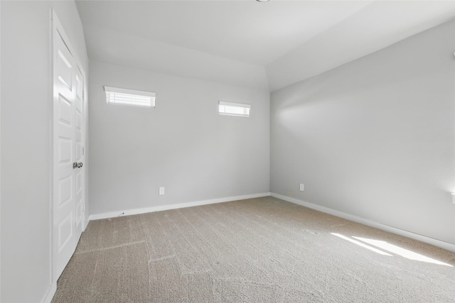 carpeted empty room with baseboards