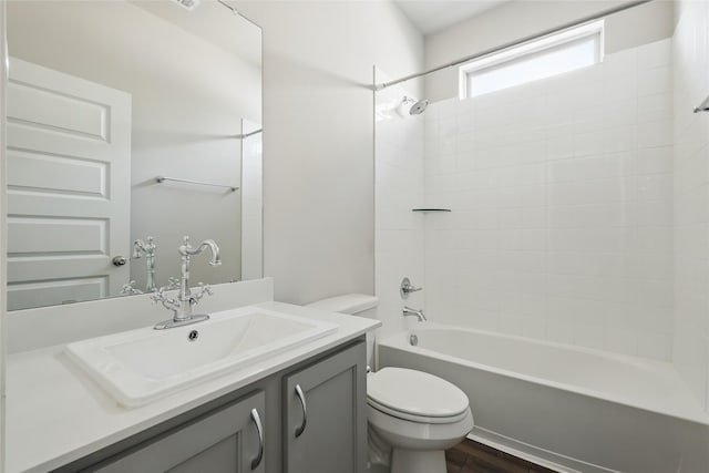 bathroom featuring shower / bathing tub combination, toilet, wood finished floors, and vanity