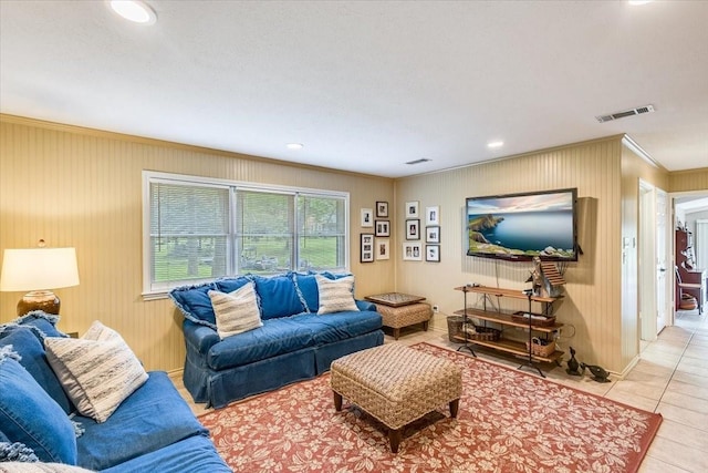 living room featuring light tile patterned floors, recessed lighting, visible vents, and ornamental molding