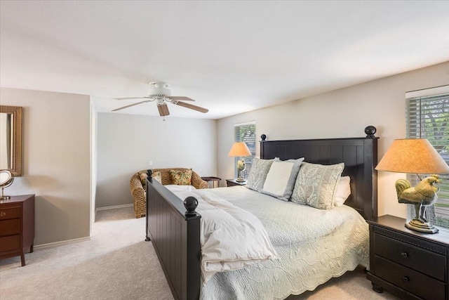 bedroom with light carpet, baseboards, and a ceiling fan