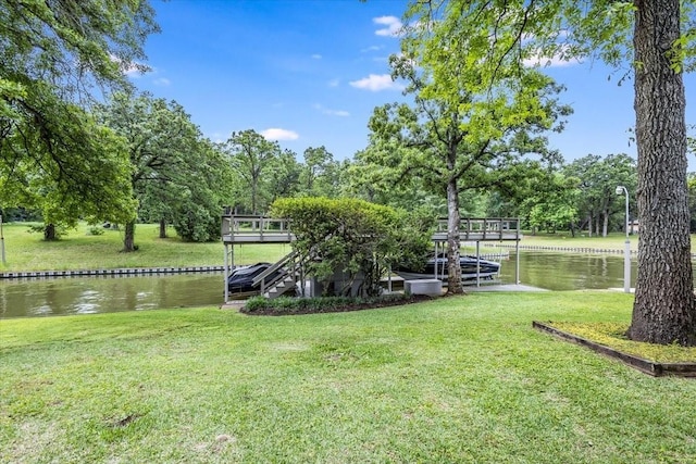 exterior space with a water view and a lawn