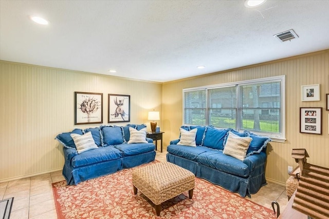 living room with light tile patterned floors, baseboards, visible vents, a textured ceiling, and recessed lighting