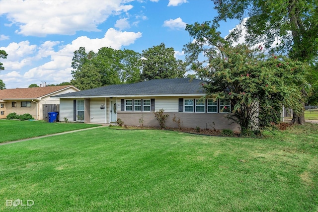 single story home featuring a garage, brick siding, and a front yard