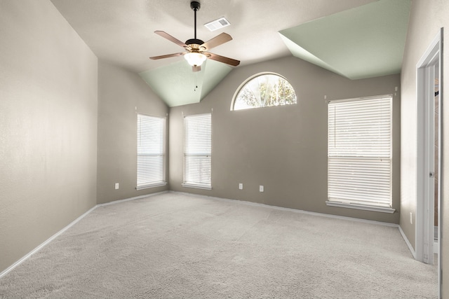 carpeted spare room featuring lofted ceiling, visible vents, ceiling fan, and baseboards