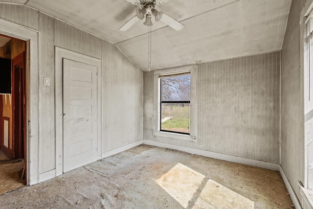 unfurnished room with vaulted ceiling and a ceiling fan