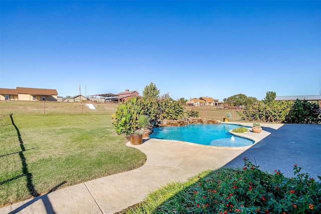 view of pool with a lawn, a patio area, fence, and a fenced in pool