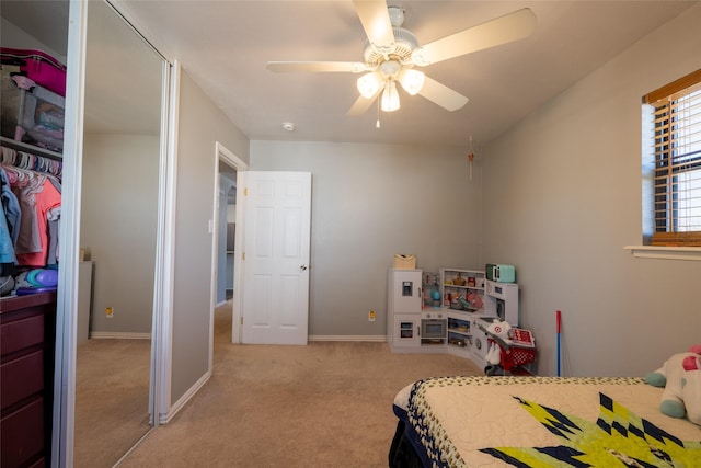 bedroom featuring carpet floors, a closet, baseboards, and a ceiling fan