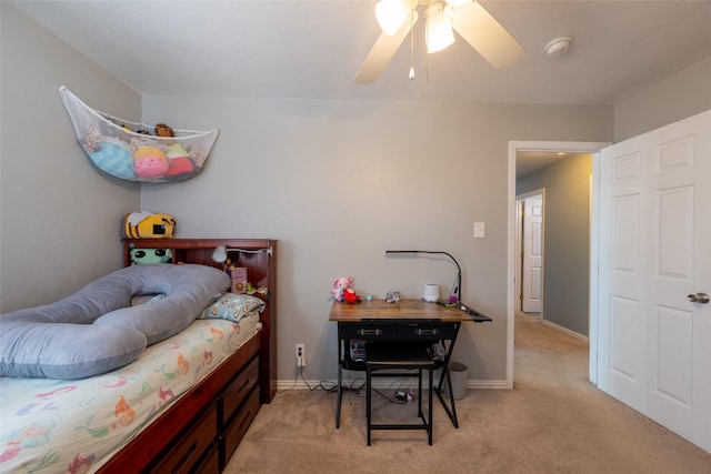 bedroom with light carpet, ceiling fan, and baseboards