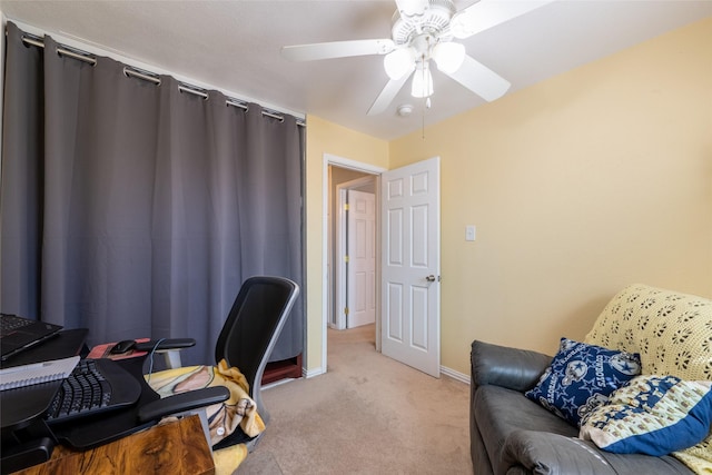 home office featuring light carpet, ceiling fan, and baseboards