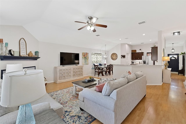 living area featuring light wood finished floors, baseboards, lofted ceiling, ceiling fan, and recessed lighting