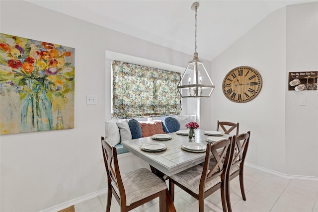 dining room with vaulted ceiling, baseboards, and light tile patterned floors