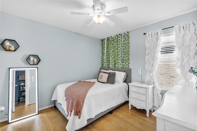 bedroom with ceiling fan and light wood-style floors