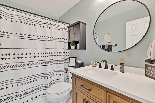 full bath featuring curtained shower, a textured wall, vanity, and toilet