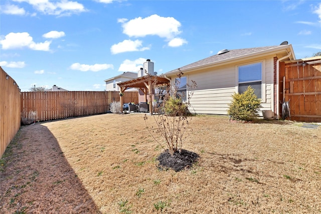 rear view of house featuring a fenced backyard, a pergola, and a yard