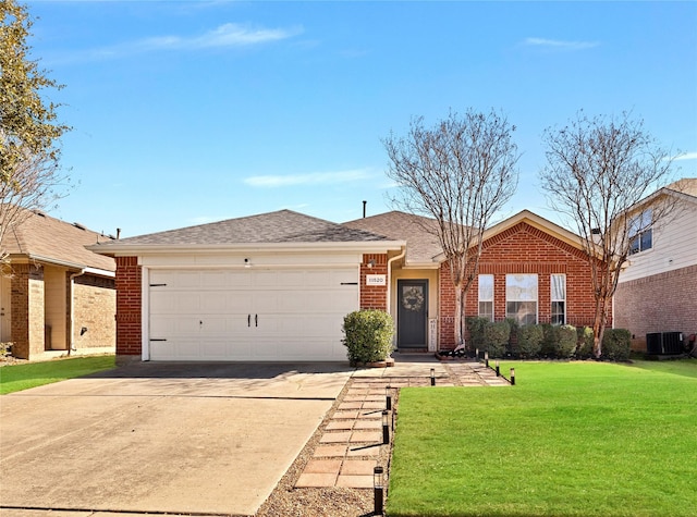 single story home with an attached garage, driveway, a front lawn, and brick siding