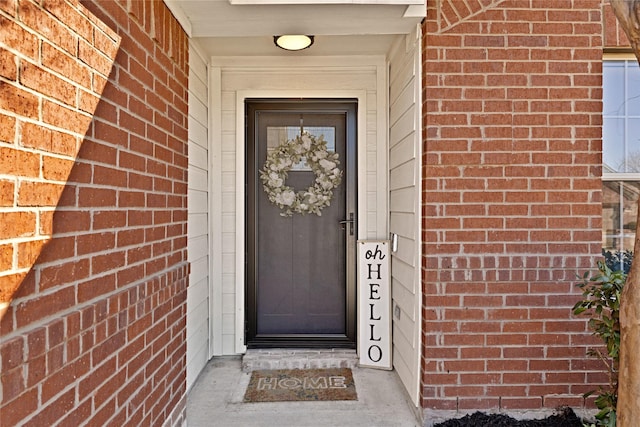 property entrance featuring brick siding