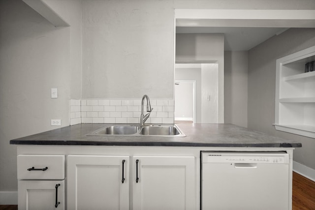 kitchen with dark wood finished floors, open shelves, white cabinetry, white dishwasher, and a sink