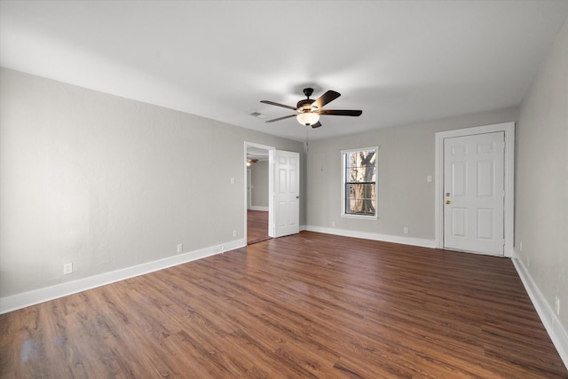 empty room featuring visible vents, baseboards, a ceiling fan, and wood finished floors