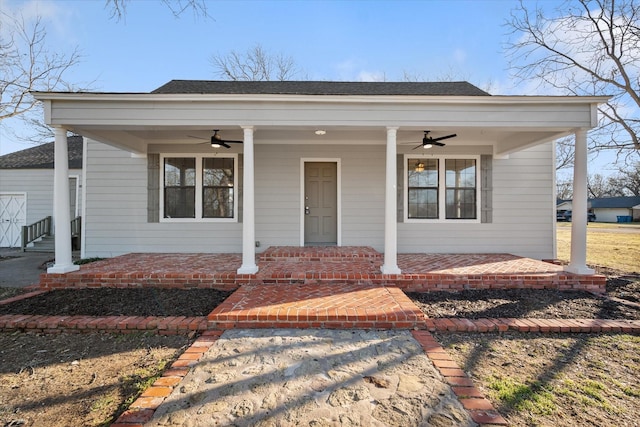 bungalow featuring ceiling fan, a porch, and roof with shingles