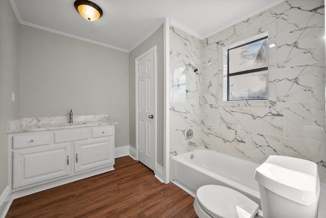 bathroom featuring toilet, ornamental molding, vanity, shower / tub combination, and wood finished floors