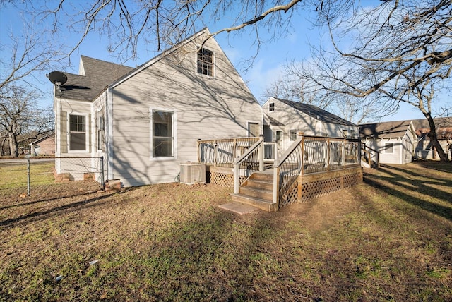 back of property featuring a yard, a shingled roof, cooling unit, and a wooden deck