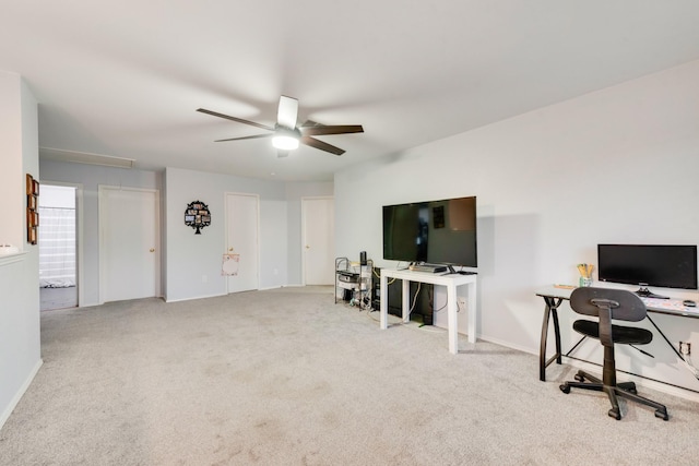 carpeted office featuring ceiling fan and attic access