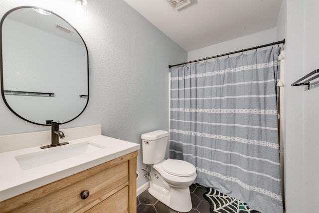 full bathroom with toilet, vanity, visible vents, and tile patterned floors