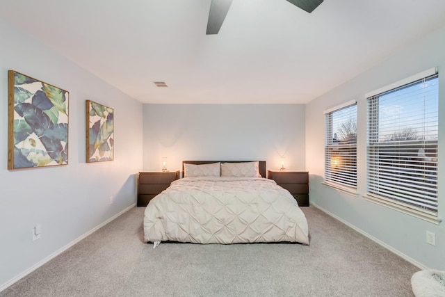 bedroom featuring ceiling fan, carpet flooring, visible vents, and baseboards