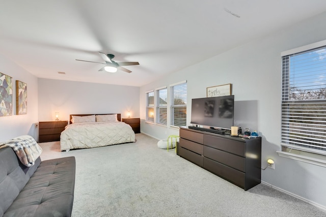 carpeted bedroom featuring visible vents, baseboards, and a ceiling fan