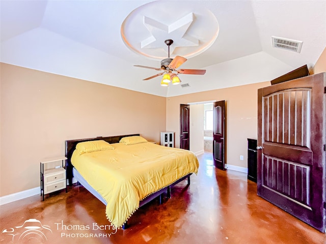 bedroom with baseboards, finished concrete floors, visible vents, and a raised ceiling