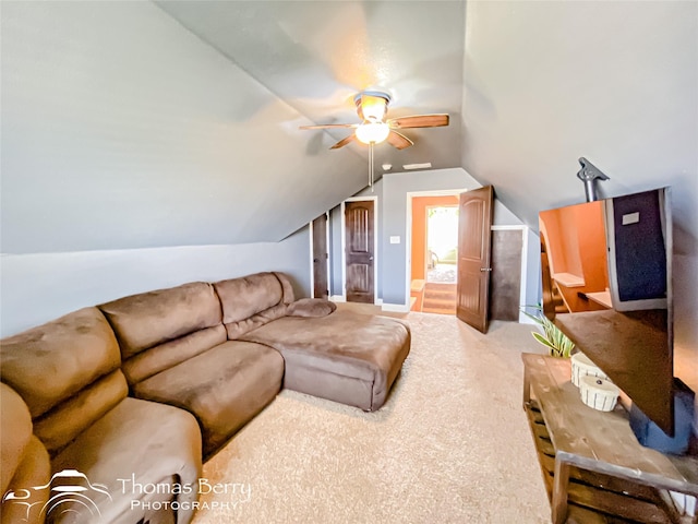 carpeted living room featuring ceiling fan and vaulted ceiling