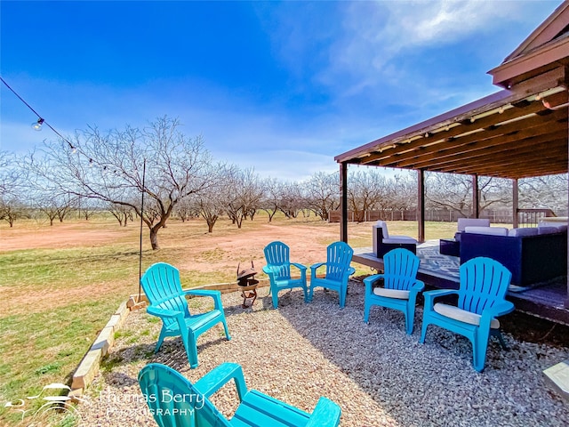 view of yard with a patio and an outdoor living space with a fire pit